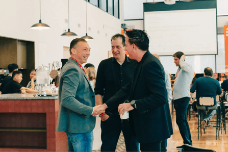 BOD members connecting and shaking hands at the company’s biggest annual event.