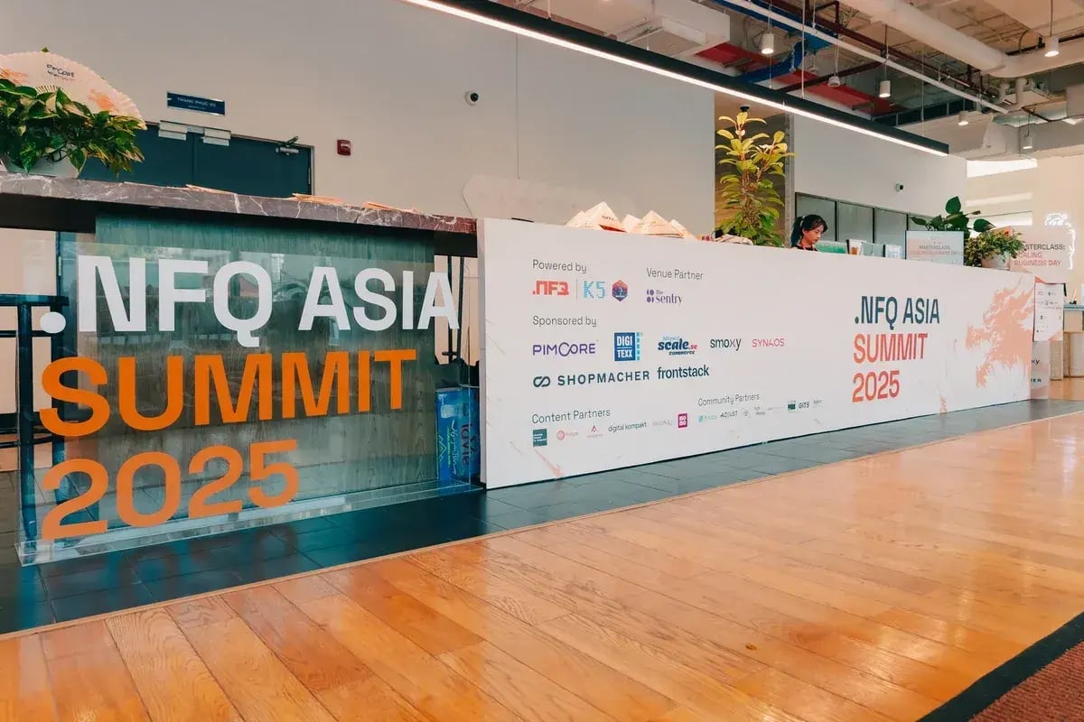Reception area with NFQ Asia Summit 2025 signage and sponsor logos