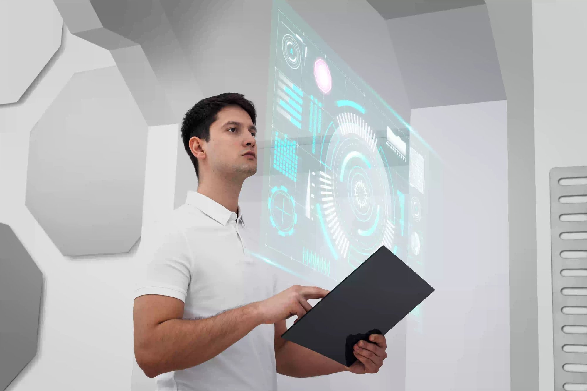 Man using a futuristic digital interface with holographic data display.